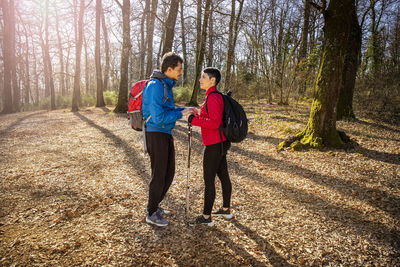 Beautiful young couple is hiking in the woods. 