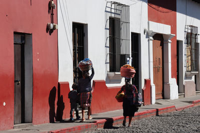 Rear view of people walking on street