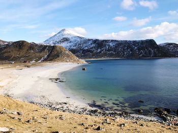 Scenic view of sea and mountains against sky