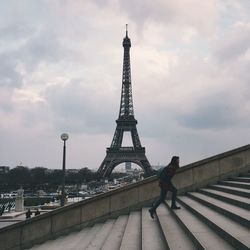 Full length side view of woman moving up on staircase in city