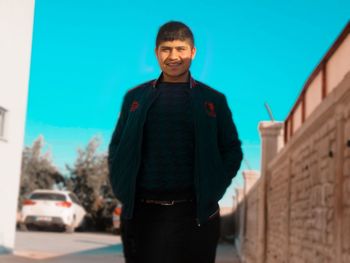 Portrait of smiling man standing in city