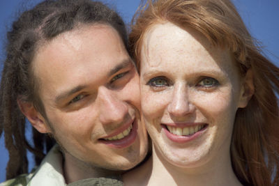 Close-up portrait of smiling young couple