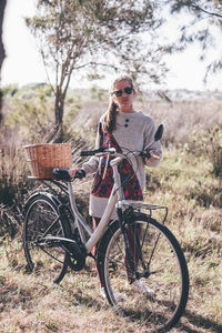 Man with bicycle on field