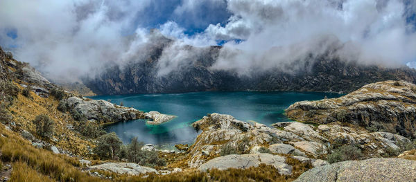 Panoramic shot of lake and rocks against sky