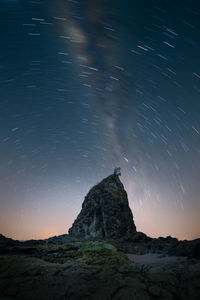 Rock formations against sky at night