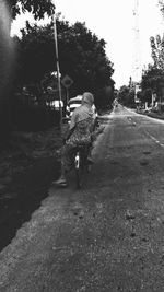 Rear view of woman walking on street