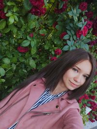 Portrait of woman smiling with plants