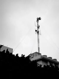 Low angle view of communications tower against sky