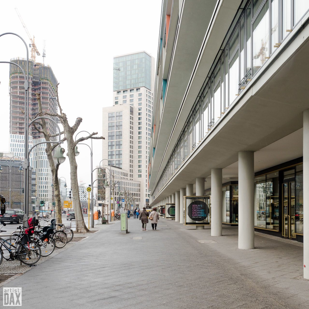 architecture, building exterior, built structure, city, the way forward, street, city life, men, walking, building, diminishing perspective, person, incidental people, clear sky, day, lifestyles, residential building, road, outdoors