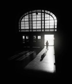 Silhouette of young man by door