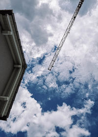 Low angle view of crane against sky