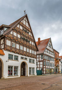 Exterior of houses in town against sky