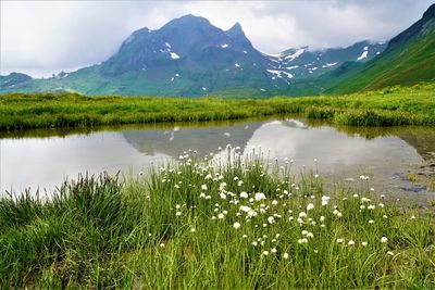 Scenic view of lake and mountains against sky