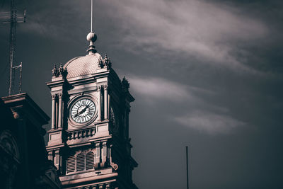 Low angle view of clock tower against sky