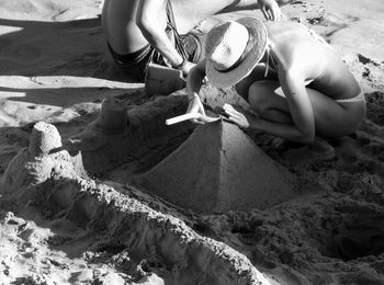 Woman making sandcastle at beach