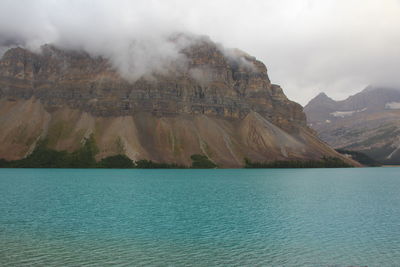 Scenic view of sea and mountains against sky