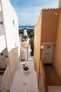 High angle view of buildings by sea against sky