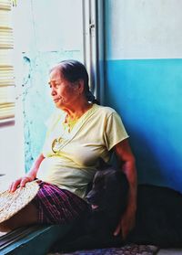 Woman with dog sitting at entrance