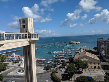 High angle view of buildings by sea against sky