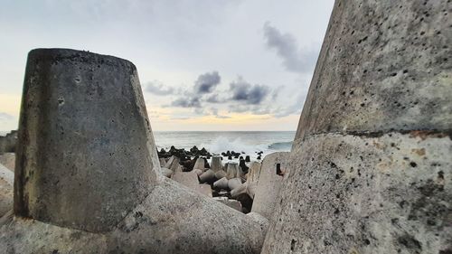 Panoramic view of rocks on beach against sky