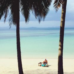 Man relaxing on lounge chair at beach