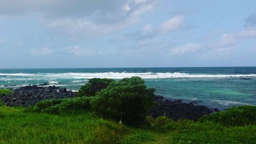 Scenic view of sea against cloudy sky