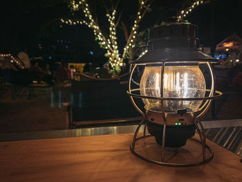 Close-up of illuminated lantern on table