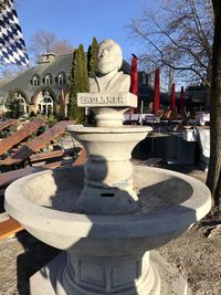 Statue in park against sky