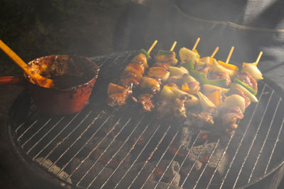 High angle view of meat on barbecue grill