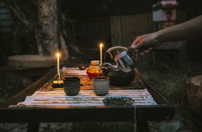 Cropped hand of person preparing food on table