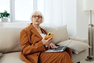 Young woman using laptop at home