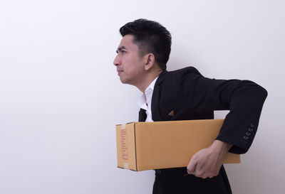 Young man standing against white background