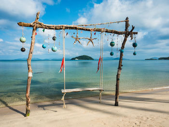 Scenic tropical island with wooden beach swing and turquoise sea. koh mak island, trat, thailand.