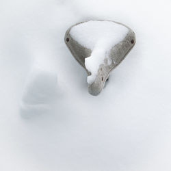 High angle view of snow covered bicycle seat