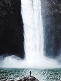 Scenic view of waterfall against sea