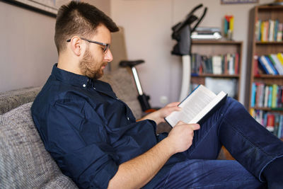 Serious man reading book at home