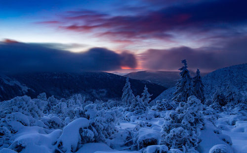 Scenic view of snowcapped mountains against sky during sunset