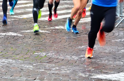 Low section of people running on street