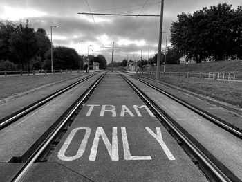 View of empty railroad tracks against sky