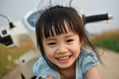Close-up of cute smiling girl looking down