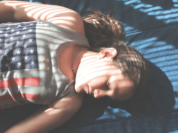 High angle view of baby lying on bed