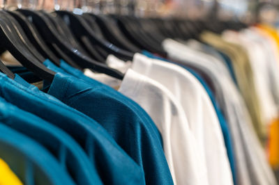 Close-up of clothes hanging on rack in store