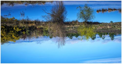 Scenic view of lake against blue sky