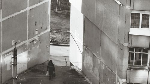 People walking on road along buildings