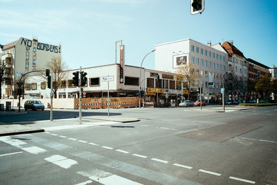 City street by buildings against sky