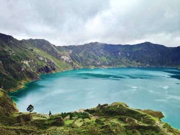 View of laguna quilotoa against cloudy sky
