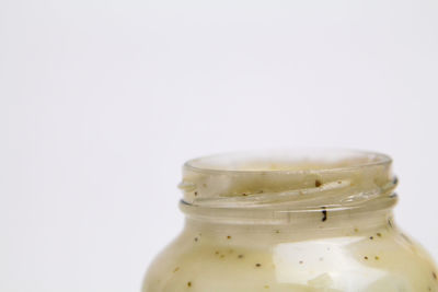 Close-up of glass jar against white background