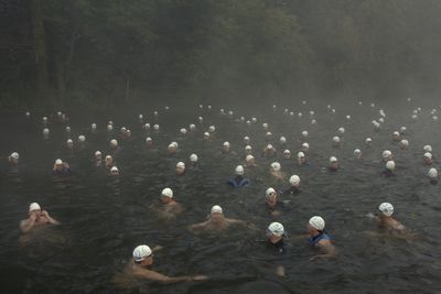 High angle view of men swimming in hot water pond