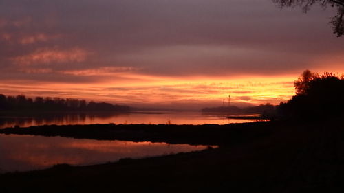 Scenic view of lake against romantic sky at sunset