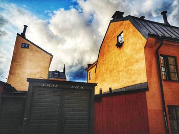 Low angle view of building against cloudy sky